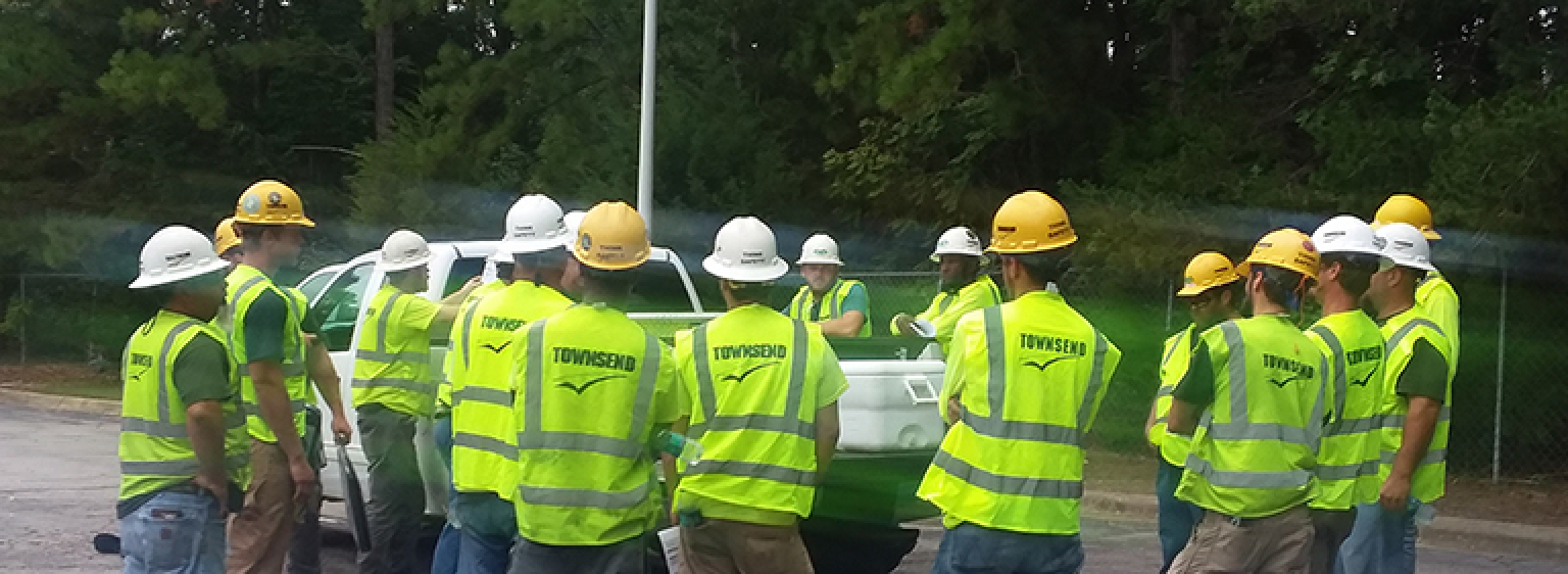 townsend employees meeting around a pickup truck planning.